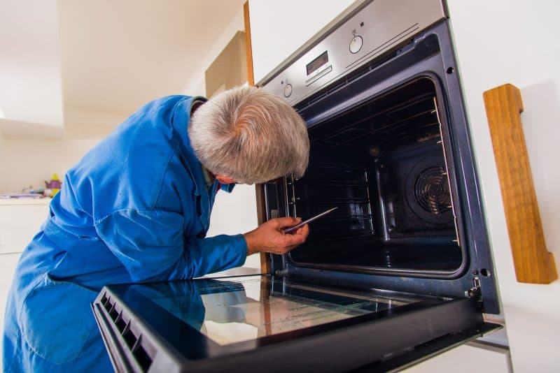 Technician repairing an oven