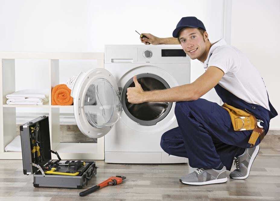 Technician repairing a washing machine